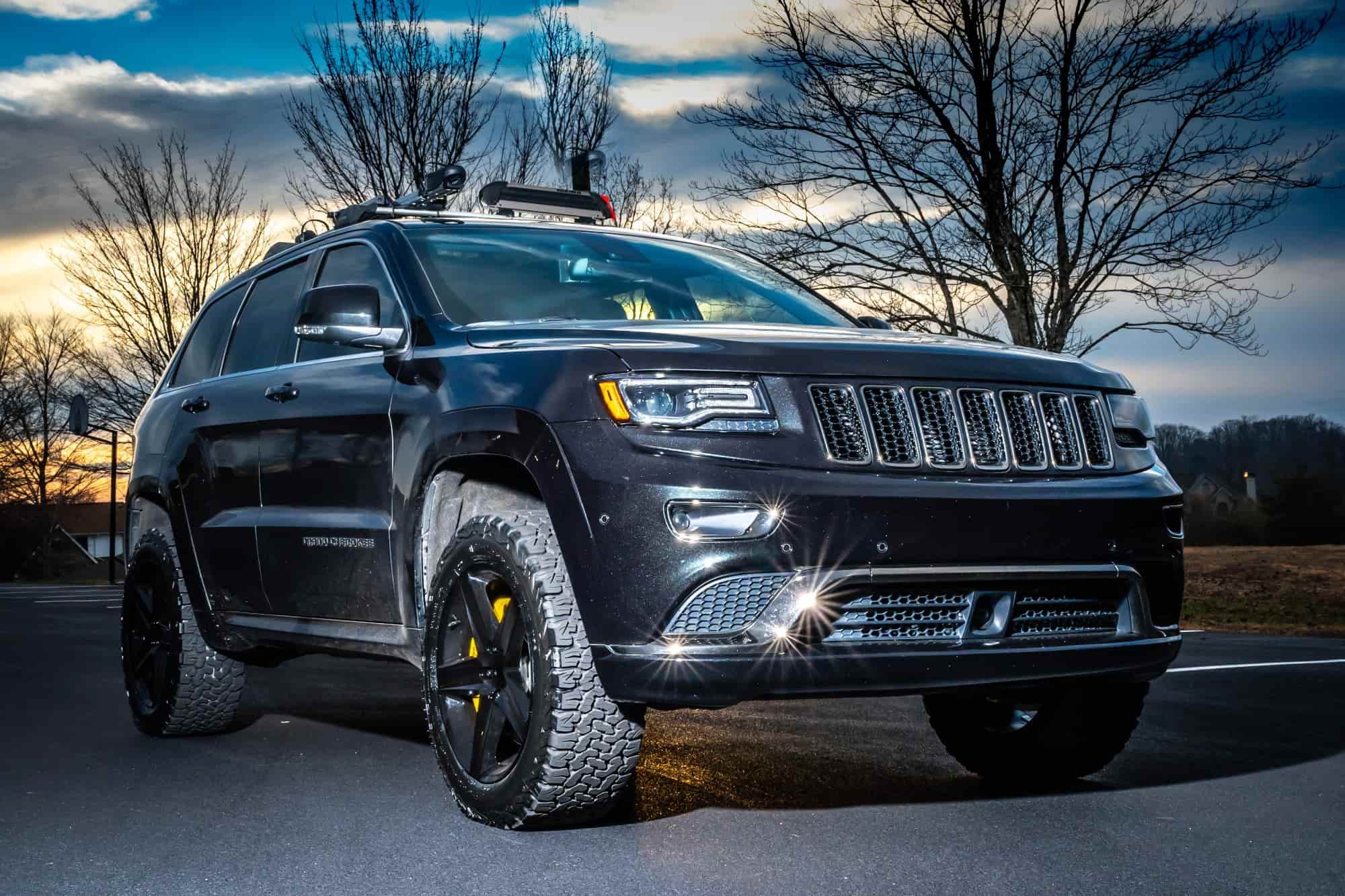 A grey 2015 Jeep Grand Cherokee running the Factory Reproductions Fr63 20x9 +34 wrapped in some tried and true BFGoodrich All Terrain Ta Ko2 275/55 and a AirLinks Leveling Kit