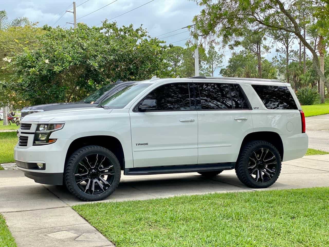 A 2016 Chevrolet Tahoe running the Factory Reproductions Fr72 22x9 +24 wrapped in Atturo Trail Blade Xt 305/45 and riding on a Maxx Leveling Kit