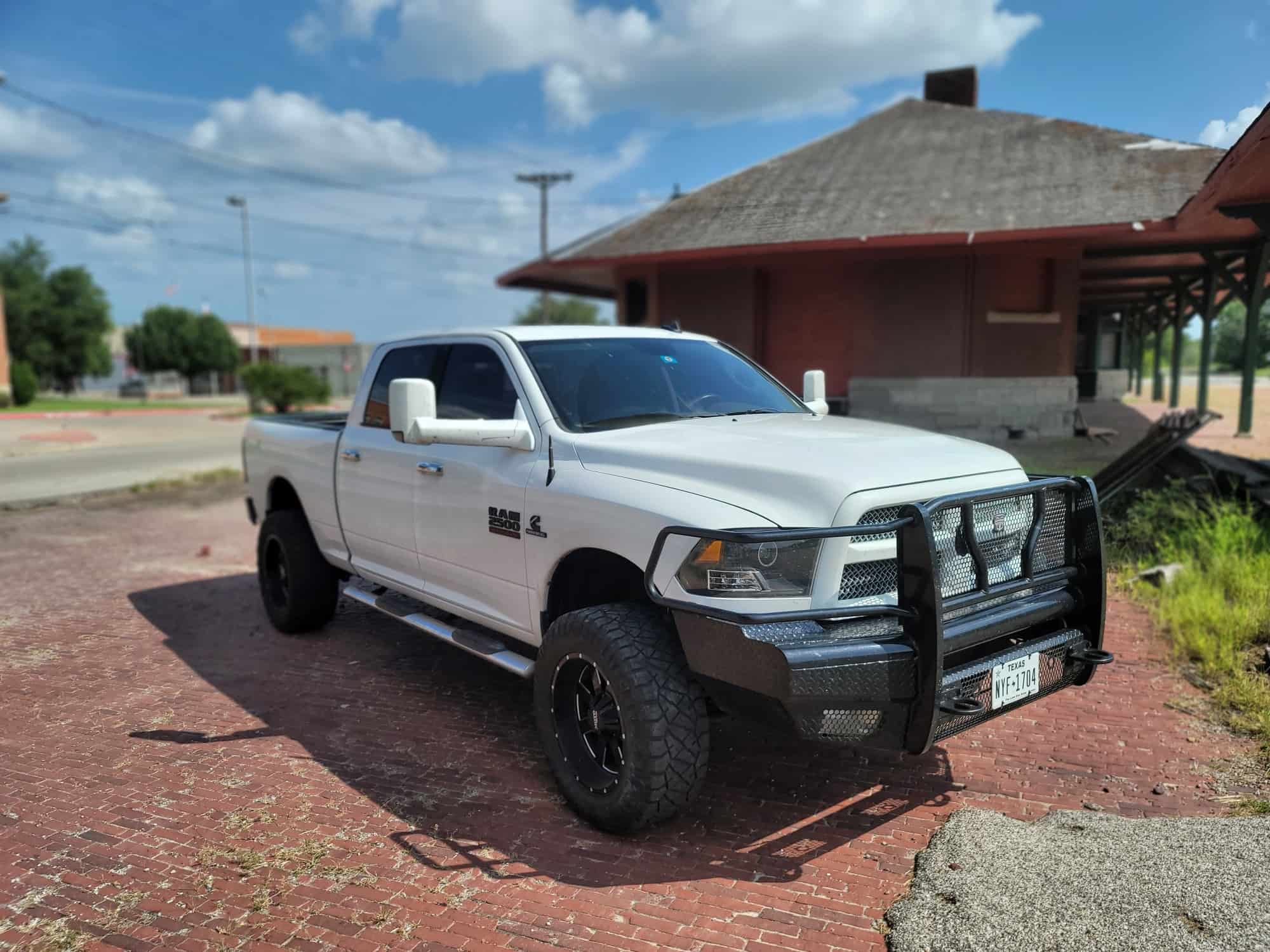A lifted, white 2015 Ram 2500 with the Moto Metal MO962